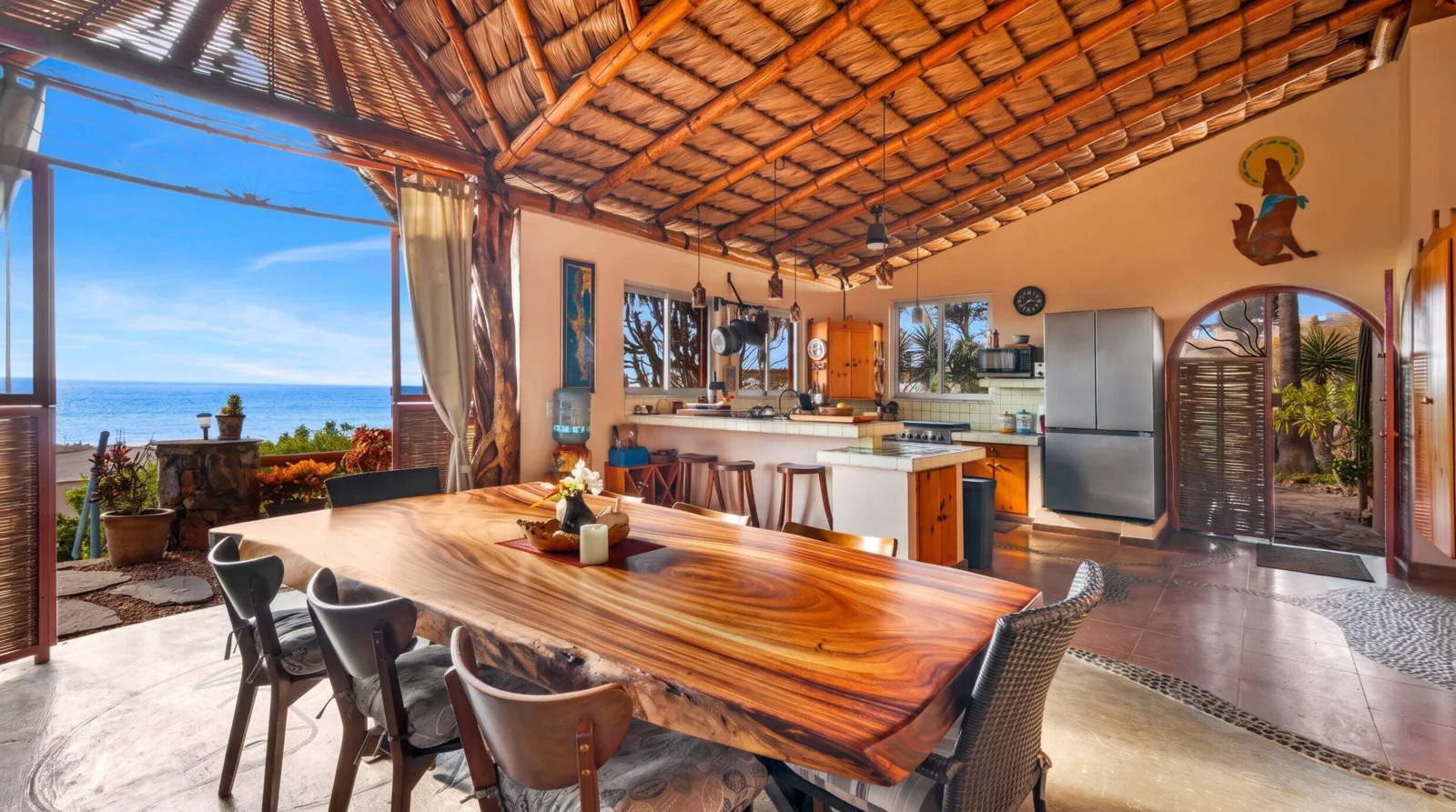 Wood dining table and ocean-facing living space